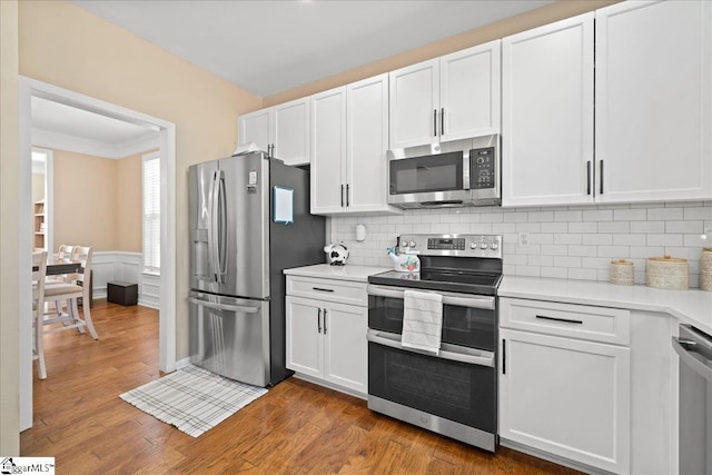 kitchen featuring white cabinetry, appliances with stainless steel finishes, and light countertops