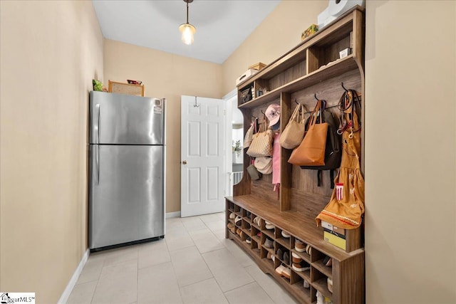 mudroom featuring baseboards and light tile patterned flooring