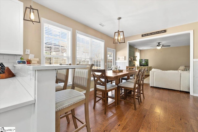 dining room with ceiling fan, dark wood-type flooring, and visible vents