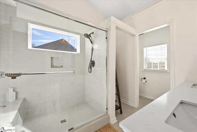 full bath with a sink, a wealth of natural light, and a shower stall