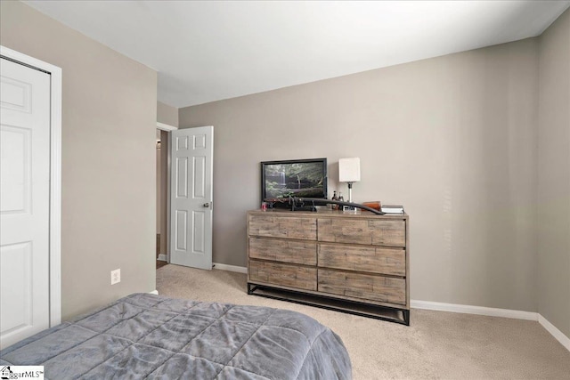 carpeted bedroom featuring baseboards