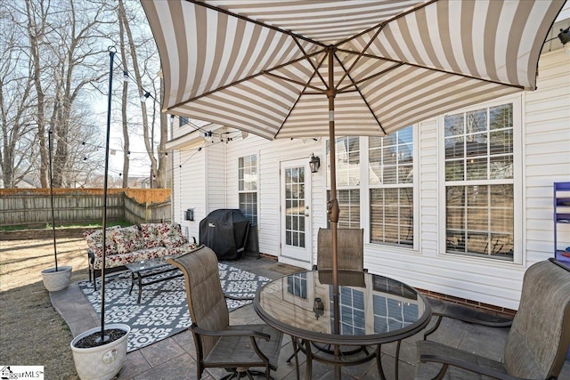 view of patio / terrace featuring outdoor dining space, fence, and area for grilling