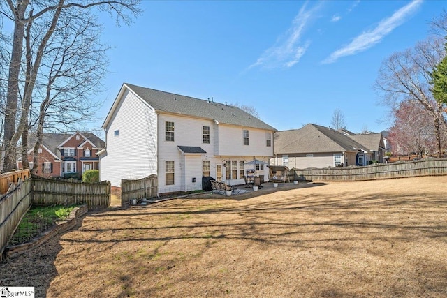 rear view of house with a yard, a patio, a fenced backyard, and a residential view