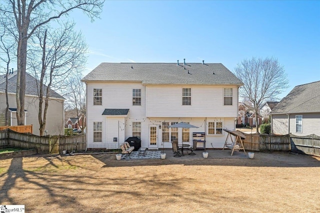 back of property featuring a patio, a yard, and fence