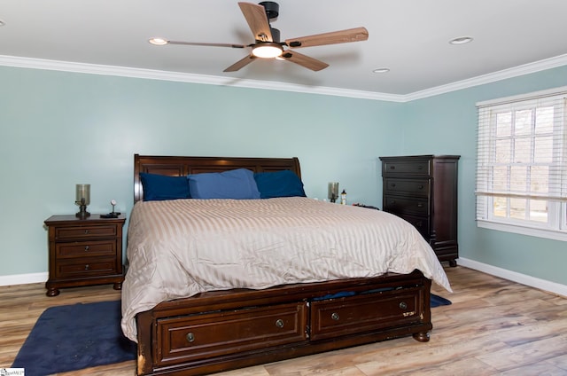 bedroom featuring ceiling fan, ornamental molding, wood finished floors, and baseboards