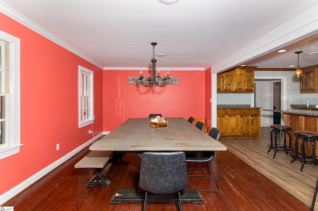 dining room featuring ornamental molding, dark wood finished floors, and baseboards