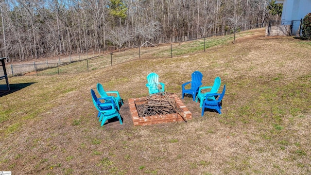 view of yard featuring an outdoor fire pit and fence