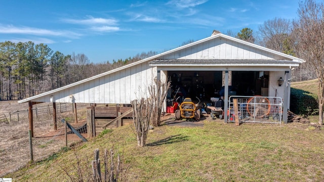 view of pole building featuring a lawn and fence