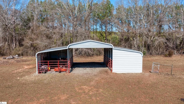 view of outbuilding featuring a detached carport and driveway