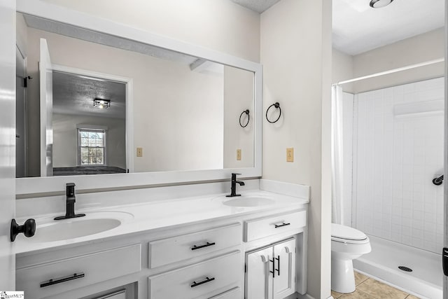 bathroom with a stall shower, tile patterned flooring, a sink, and double vanity