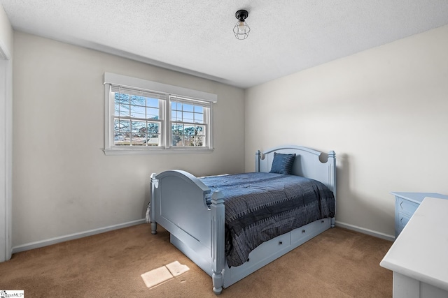 carpeted bedroom featuring baseboards and a textured ceiling