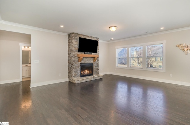 unfurnished living room with dark wood-style floors, ornamental molding, a fireplace, and baseboards