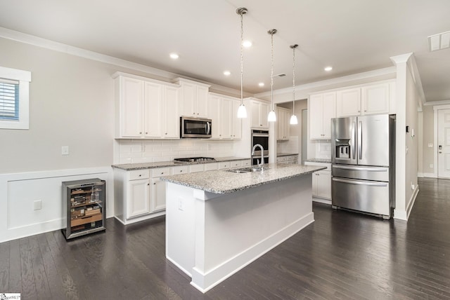 kitchen featuring white cabinets, wine cooler, appliances with stainless steel finishes, a sink, and backsplash