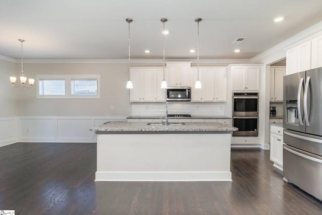 kitchen featuring dark wood-type flooring, a sink, appliances with stainless steel finishes, backsplash, and crown molding