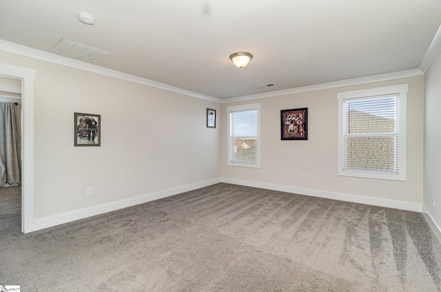 empty room with a wealth of natural light, visible vents, crown molding, and carpet flooring