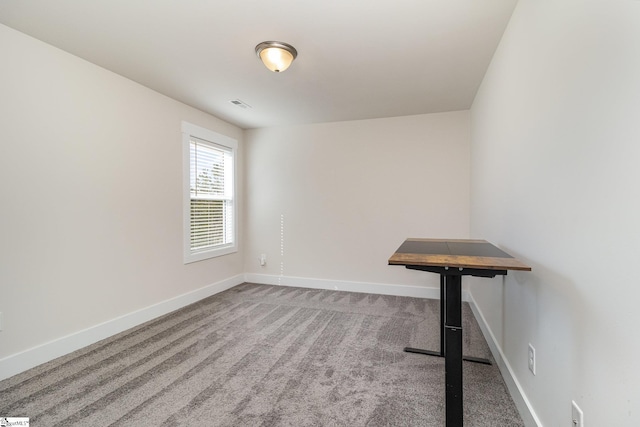 unfurnished room with carpet, baseboards, and visible vents