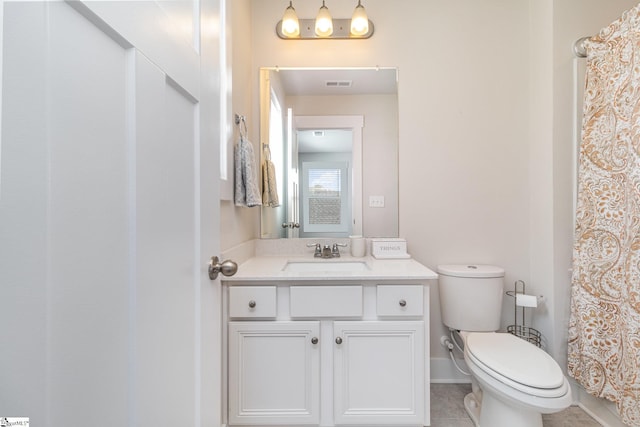 bathroom with baseboards, visible vents, toilet, tile patterned floors, and vanity