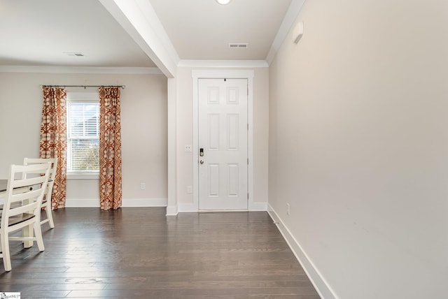 entrance foyer featuring dark wood-style floors, visible vents, crown molding, and baseboards