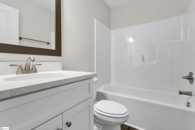 full bathroom featuring toilet, washtub / shower combination, and vanity