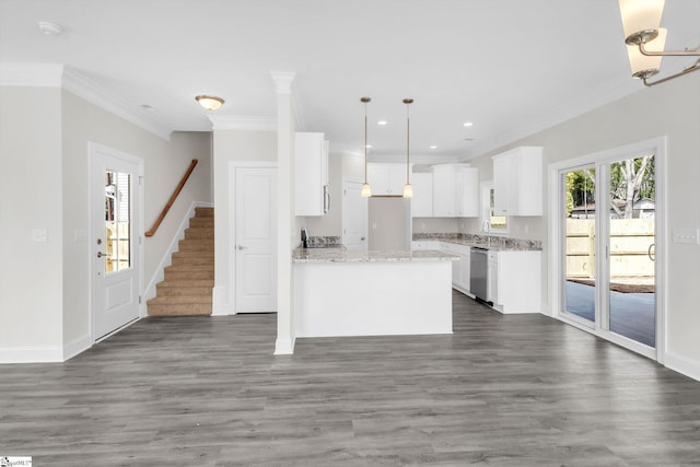 kitchen featuring a peninsula, white cabinets, stainless steel appliances, and wood finished floors