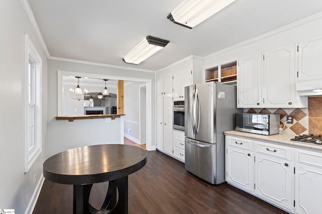 kitchen featuring appliances with stainless steel finishes, tasteful backsplash, white cabinets, and dark wood-style floors