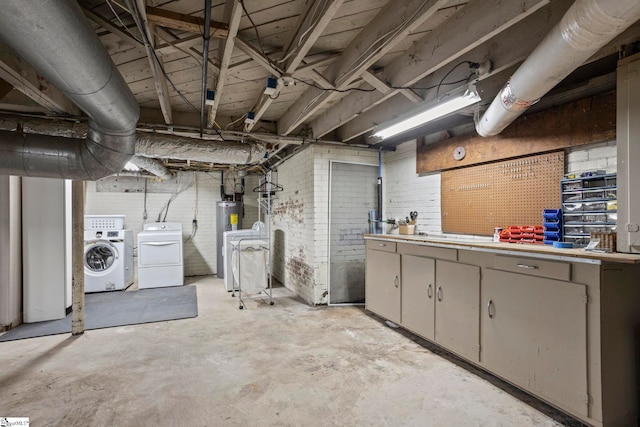 unfinished below grade area with brick wall, electric water heater, a workshop area, and independent washer and dryer