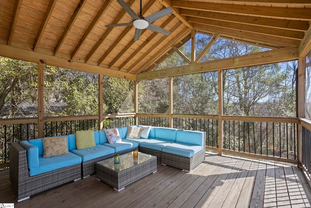 unfurnished sunroom featuring lofted ceiling with beams, a healthy amount of sunlight, and a ceiling fan