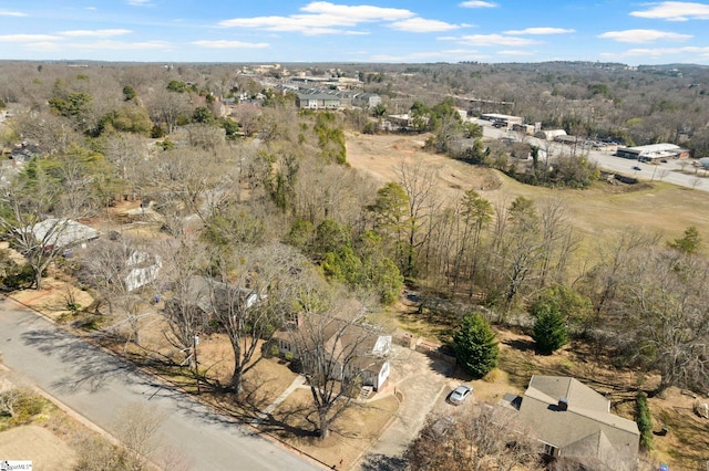 bird's eye view featuring a wooded view