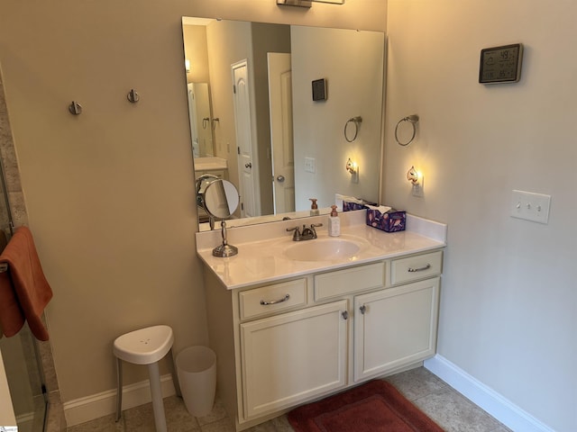 full bath with vanity and baseboards