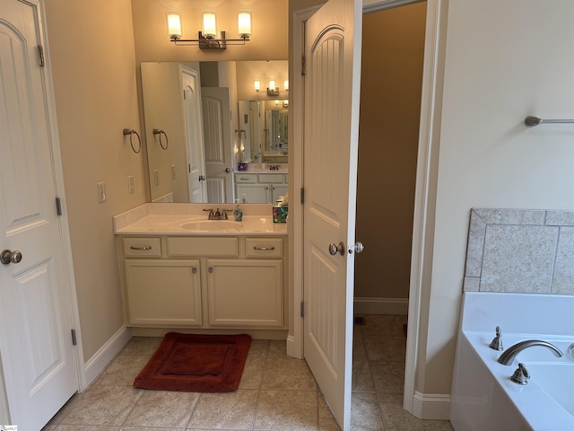 full bathroom with vanity, tile patterned flooring, a bath, and baseboards