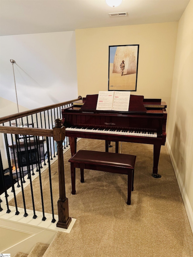 sitting room with carpet flooring, visible vents, and baseboards