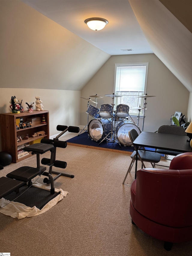 workout area featuring lofted ceiling, carpet flooring, and visible vents