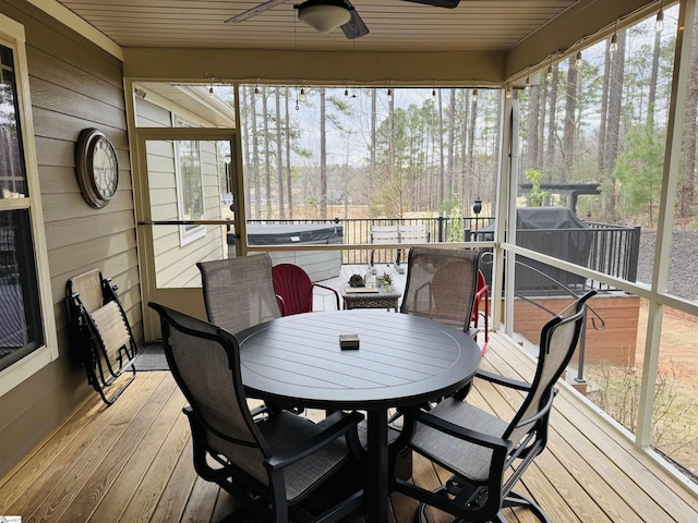 sunroom / solarium featuring a ceiling fan and plenty of natural light