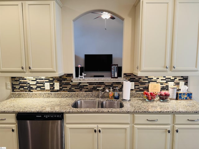 kitchen with a ceiling fan, a sink, stainless steel dishwasher, and tasteful backsplash