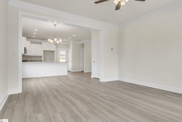 unfurnished living room featuring baseboards, light wood-style flooring, ornamental molding, ceiling fan with notable chandelier, and recessed lighting