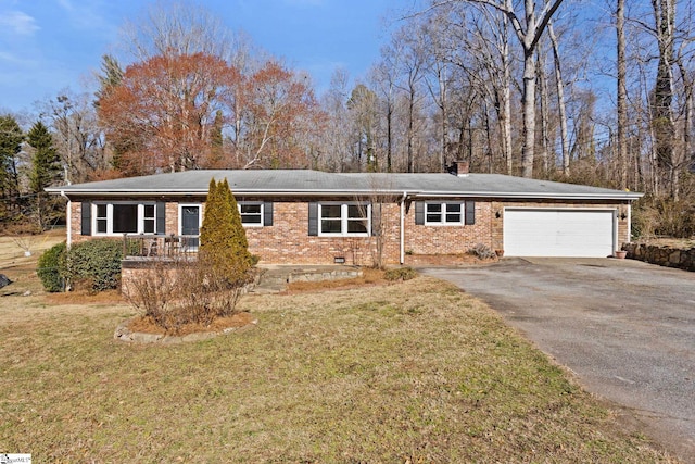 single story home with driveway, crawl space, an attached garage, a front lawn, and brick siding