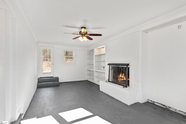 unfurnished living room featuring ceiling fan, ornamental molding, concrete floors, and a fireplace