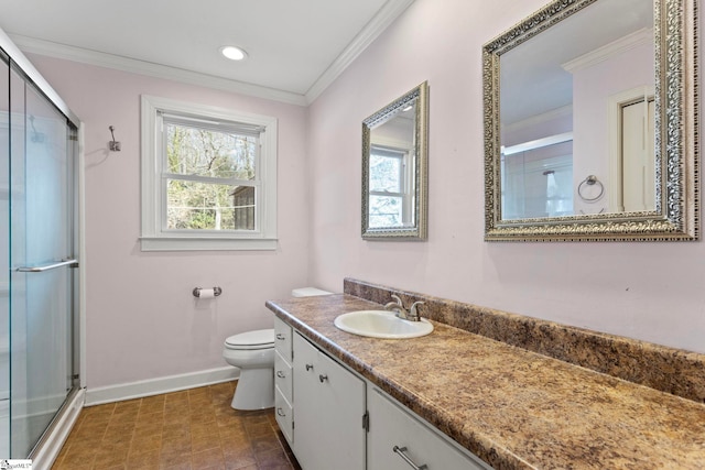 full bath with crown molding, toilet, a shower stall, vanity, and baseboards