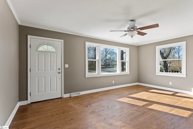 foyer featuring ornamental molding, visible vents, baseboards, and wood finished floors