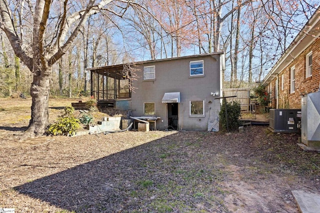 rear view of house featuring cooling unit