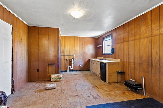 kitchen featuring wood walls, brown cabinets, and a sink