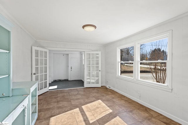 interior space featuring crown molding, french doors, and baseboards