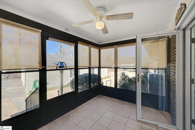 unfurnished sunroom featuring ceiling fan