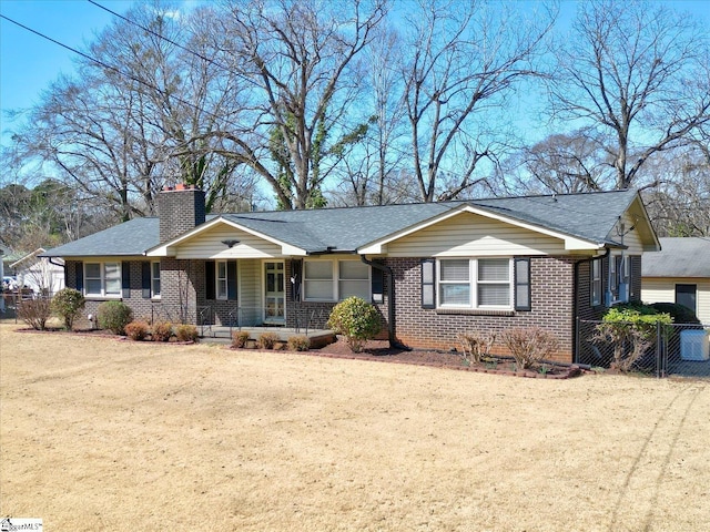 ranch-style house with brick siding, roof with shingles, a chimney, fence, and driveway