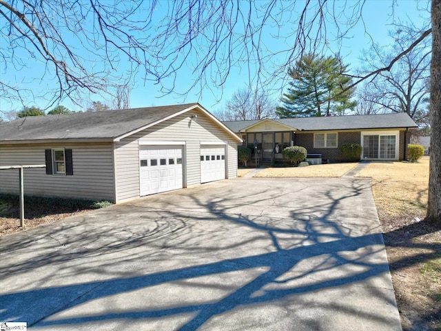 ranch-style house with brick siding and a detached garage