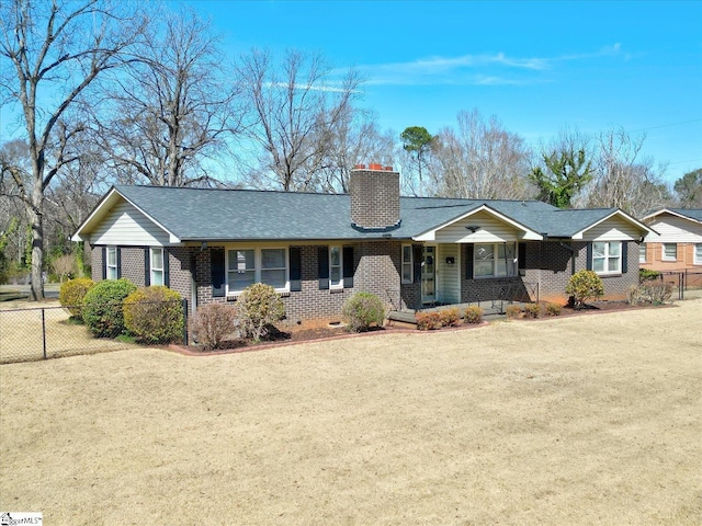 ranch-style home featuring a chimney, crawl space, fence, a front lawn, and brick siding