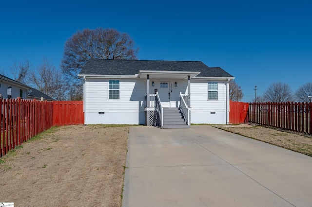 view of front facade featuring crawl space, covered porch, and roof with shingles