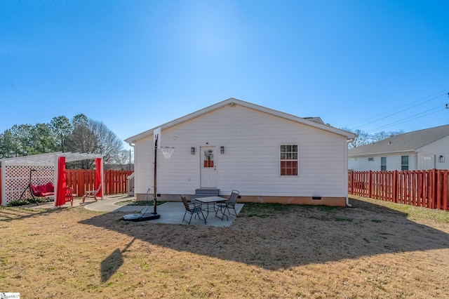 back of property featuring crawl space, a patio area, fence, and a lawn