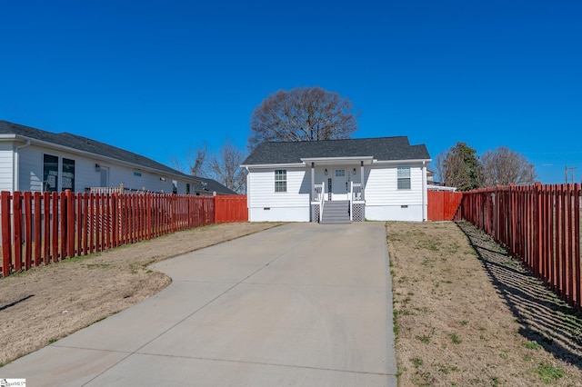 view of front of property with crawl space and a fenced backyard