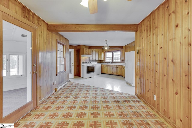 kitchen with white appliances and wooden walls